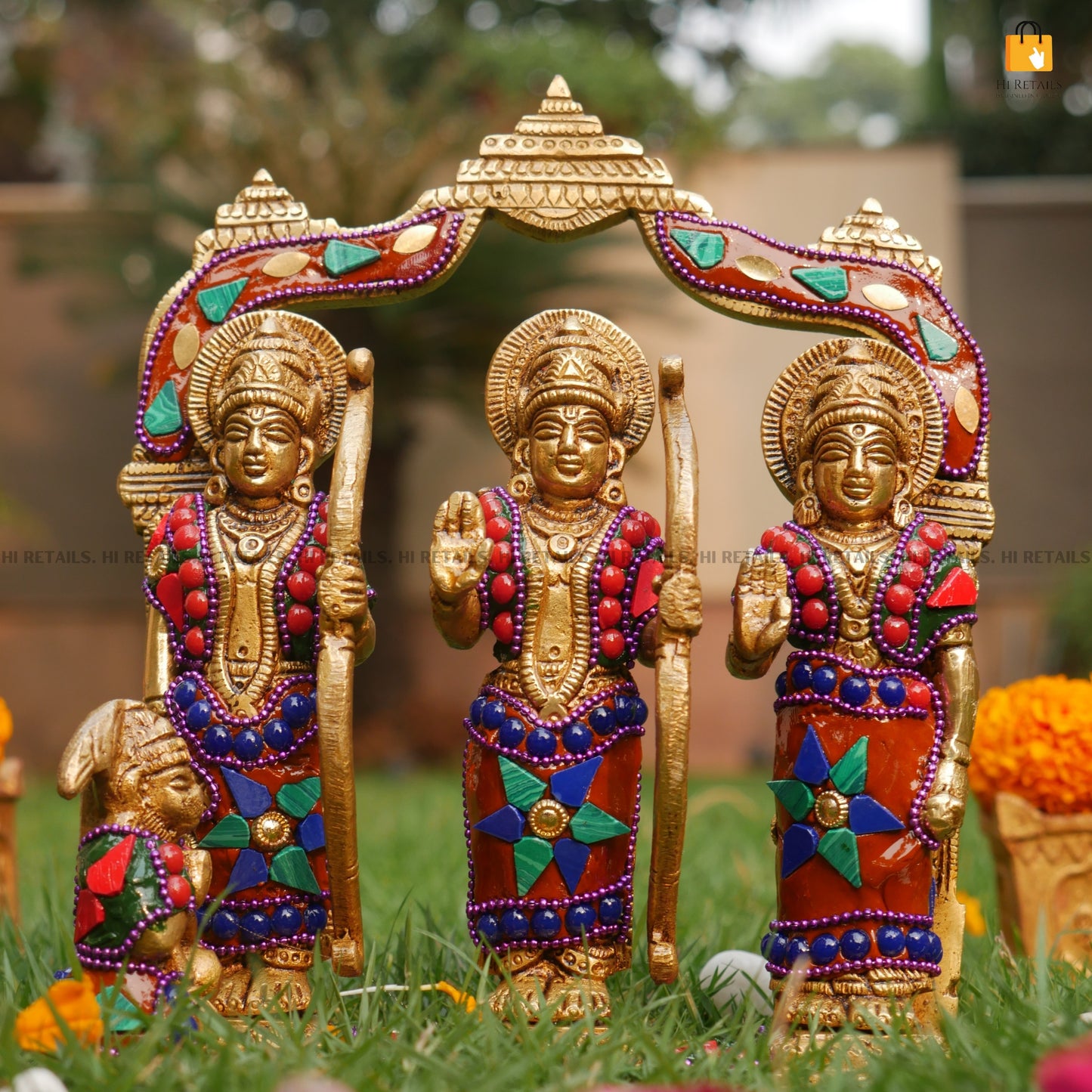 Elegant Brass Ram Darbar Statue featuring Lord Ram, Sita, and Lakshman, adorned with vibrant gemstones, ideal for spiritual decor. Available at www.hiretails.com.