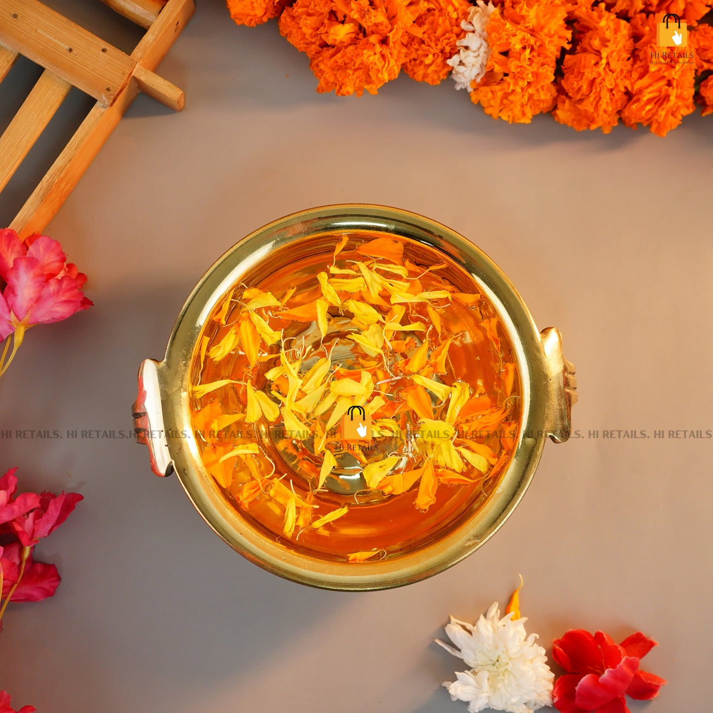 Brass Urli with Floral Arrangement for Festivals and Spiritual Ceremonies | Traditional Brass Urli for Home at www.hiretails.com
