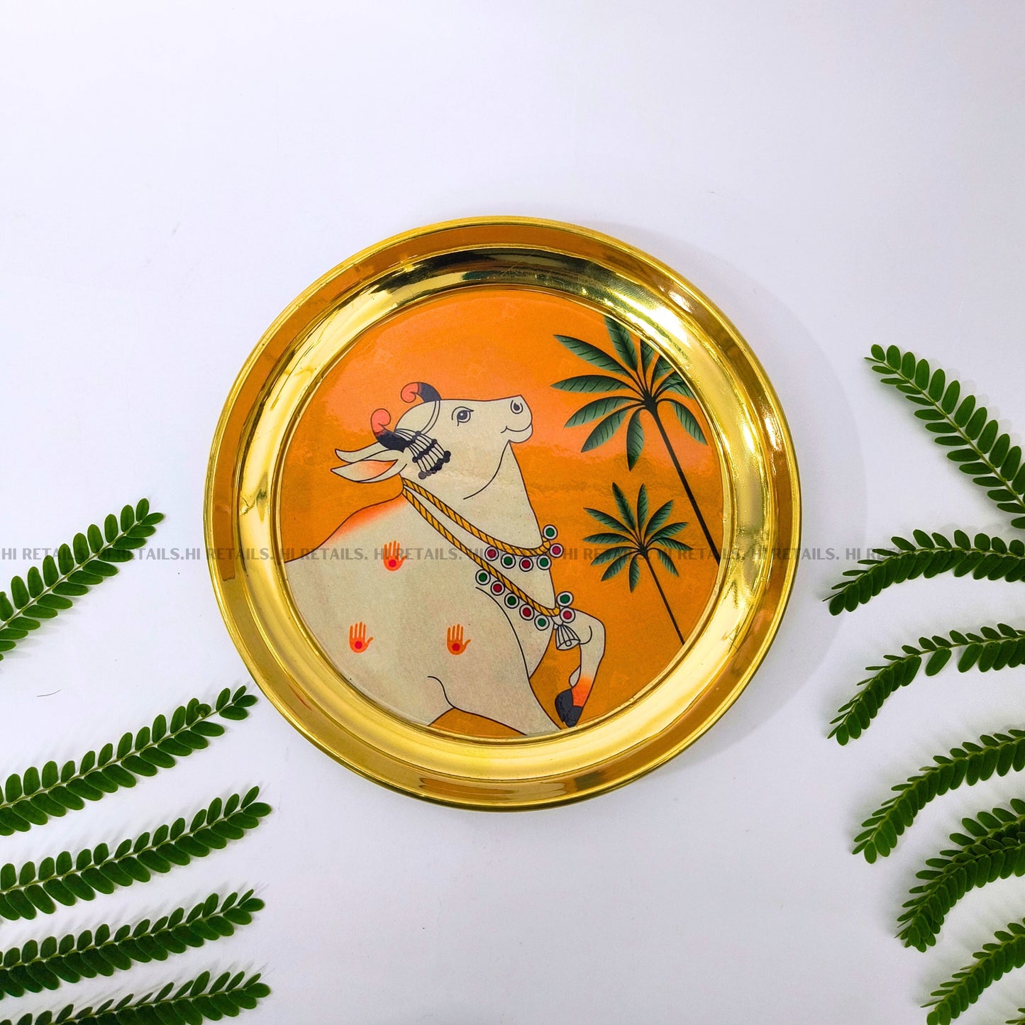Elegant Pichwai art cow plate with brass finish, perfect for decorative purposes and spiritual spaces at www.hiretails.com
