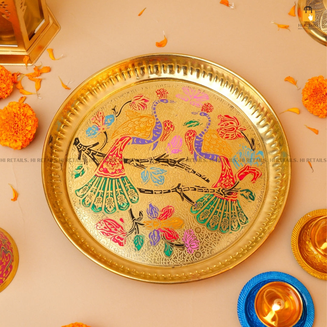 Elegant brass Pooja thali with vibrant colors and decorative elements, ideal for your home temple. Available at www.hiretails.com.