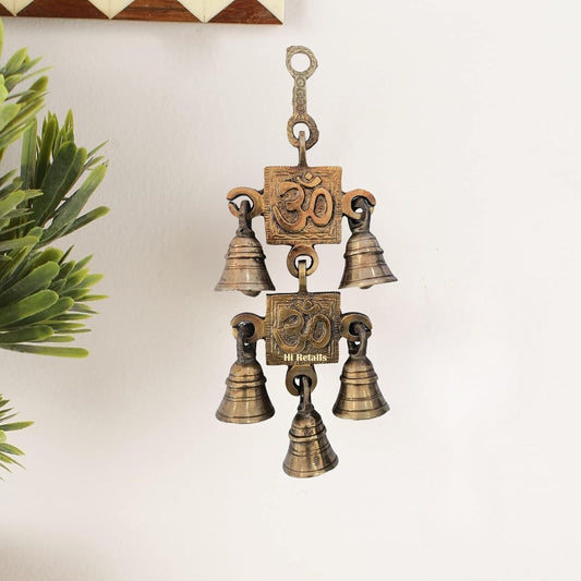 Brass Om Swastik hanging bell for door and room decor, an elegant piece for spiritual and traditional settings at www.hiretails.com