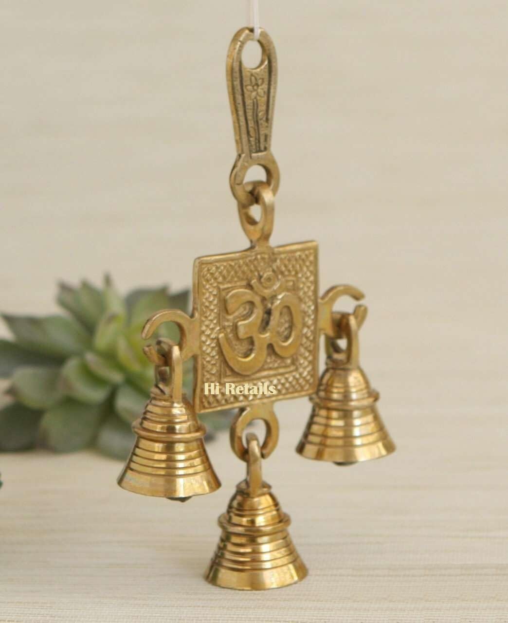 Om brass hanging bells with four bells for temple or door decor, adding spiritual elegance to your home at www.hiretails.com
