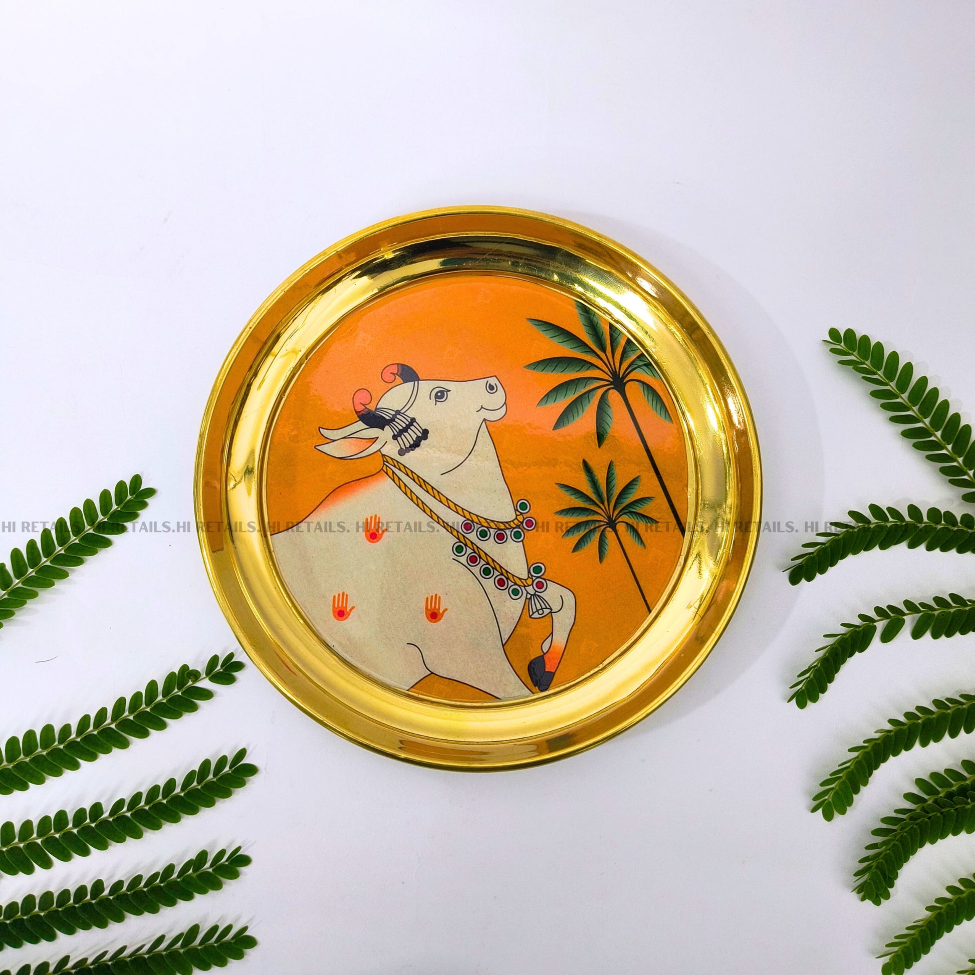 Elegant Pichwai art cow plate with brass finish, perfect for decorative purposes and spiritual spaces at www.hiretails.com