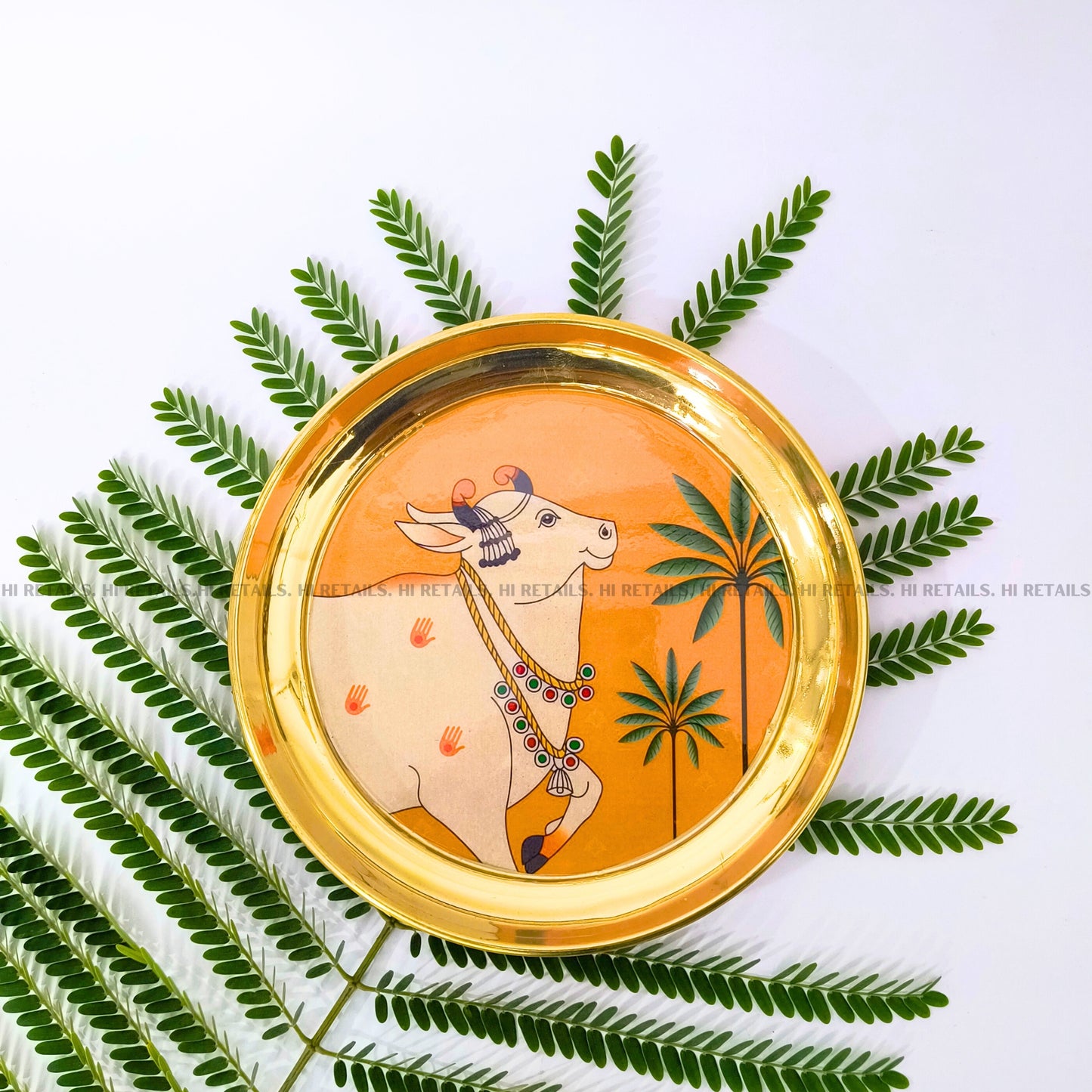 Traditional brass plate with Pichwai cow print, a unique decorative piece for pooja mandir at www.hiretails.com