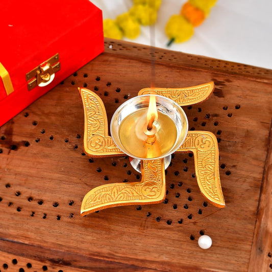 Brass oil lamp with decorative stand and box, perfect for pooja rituals and home decor. Create a peaceful atmosphere with this elegant piece. Available at www.hiretails.com.