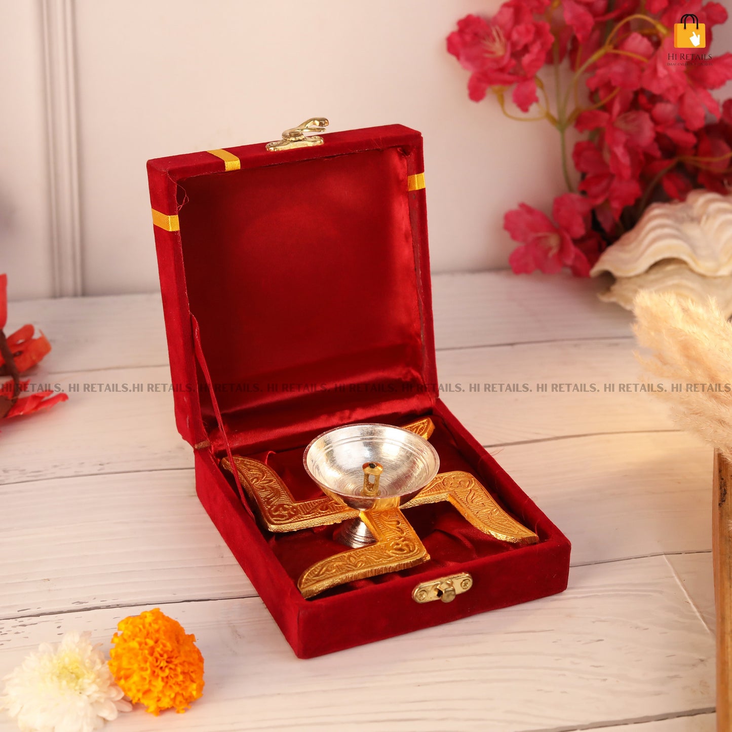 Brass diya with ornate stand and box, a charming addition to your pooja room or home decor for a warm glow and peaceful atmosphere. Available at www.hiretails.com.