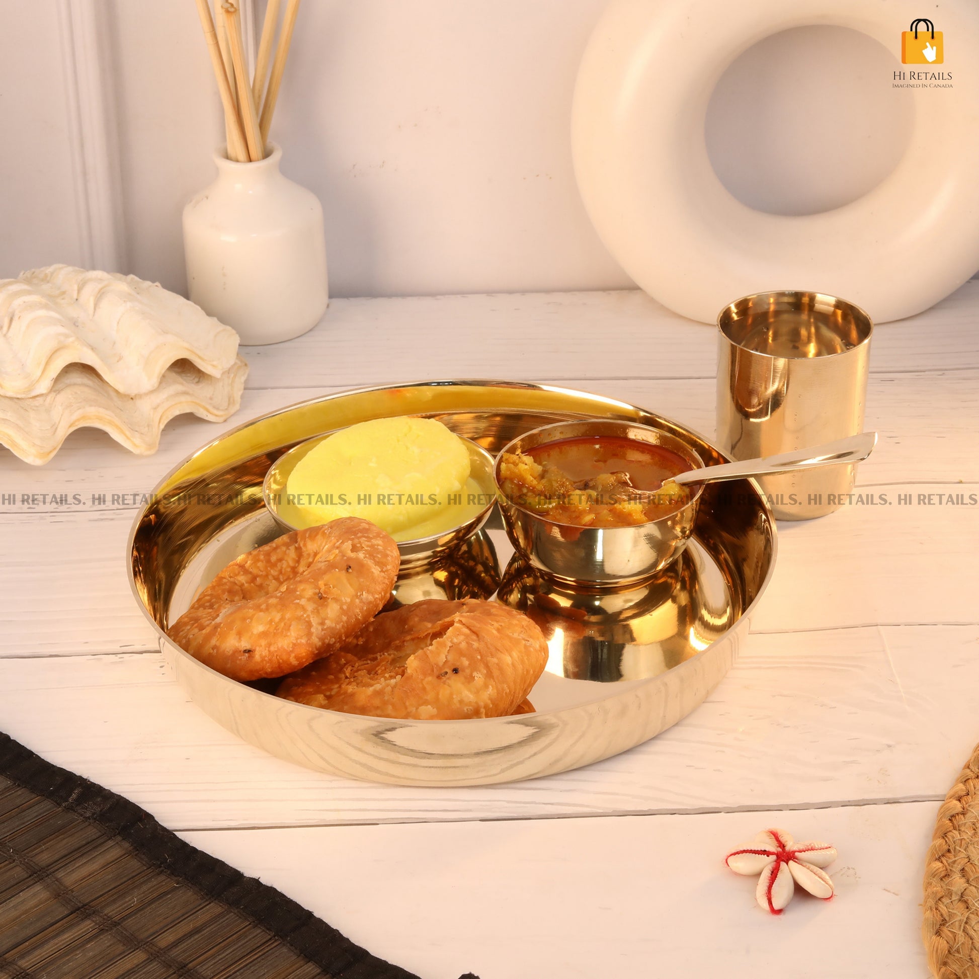 Durable kansa thali dinnerware set, including bowls and spoons, perfect for your dining table at www.hiretails.com