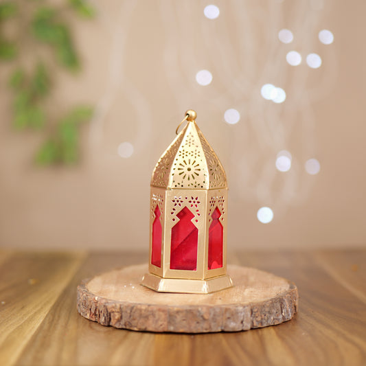 Elegant brass round hanging lamp with red glass, offering a warm, ambient glow and intricate design, perfect for home décor. Available at www.hiretails.com.